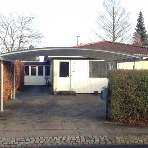 Dobbelt carport foran parcelhus med plads til to biler i Skovlunde