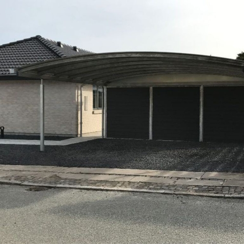 Carport med skur i mørkt design og overdækket parkering.