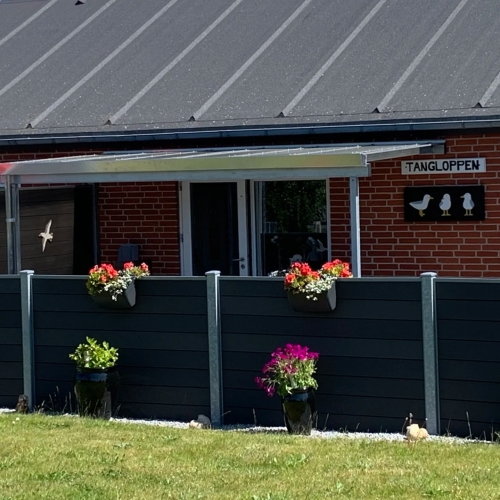 Terrasseoverdækning ved rækkehus med privat terrasse og blomster